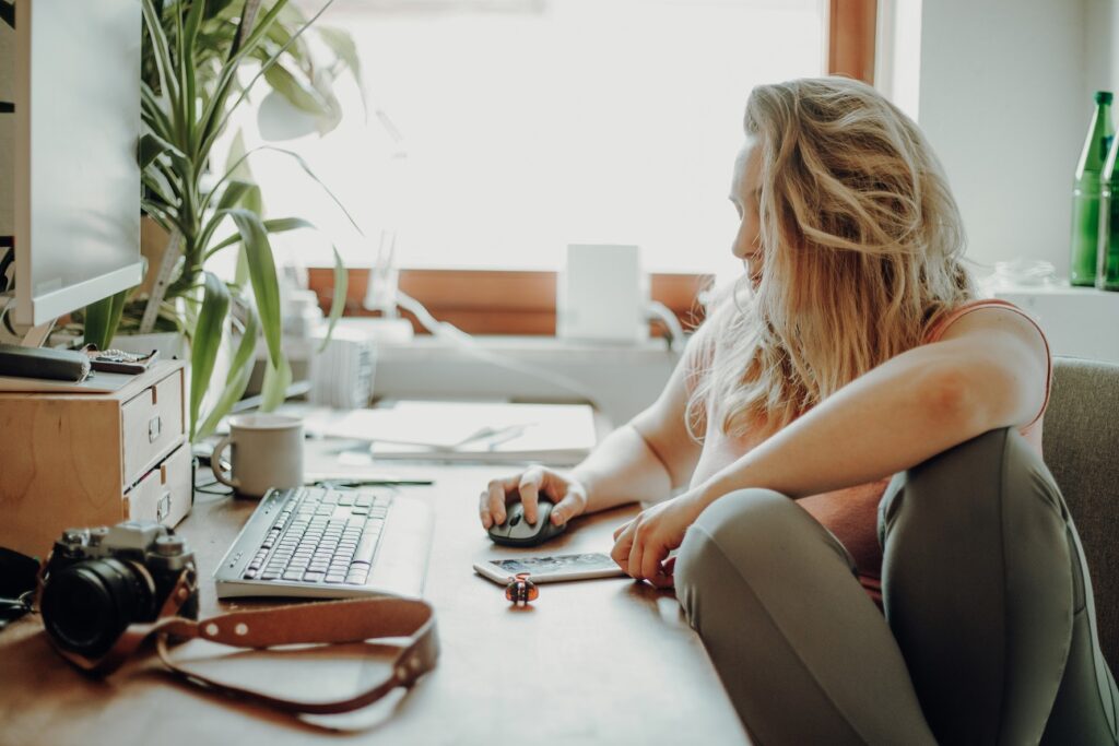 Creative Person working in home office looking at computer screen.