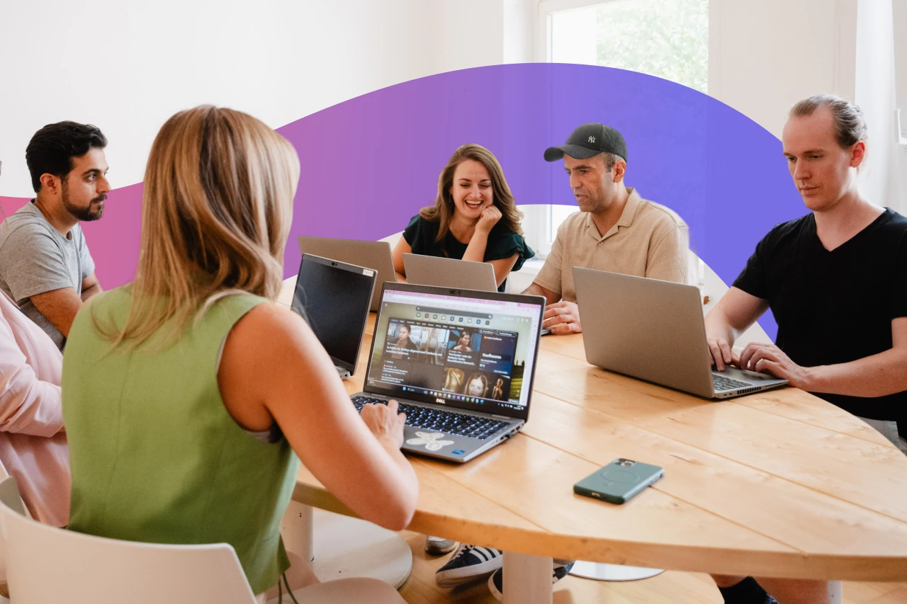 students around a table on their laptops - online vs inperson coding boodtamp